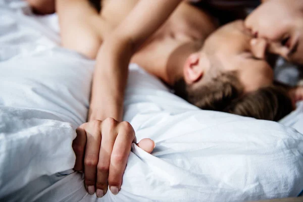 Selective focus of woman and man having sex in bed — Stock Photo
